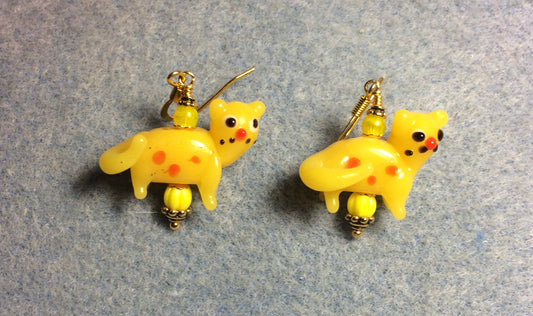 Opaque yellow lamp work spotted cat bead earrings adorned with yellow Czech glass beads.