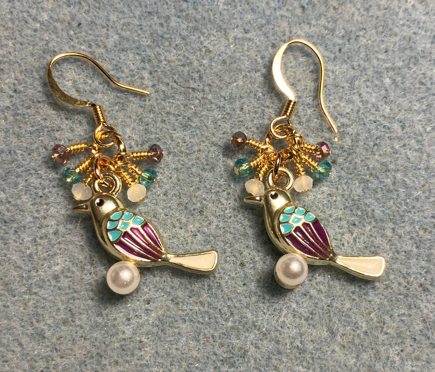 Violet, turquoise, and white enamel finch charm earrings adorned with tiny dangling violet, turquoise, and white Chinese crystal beads.