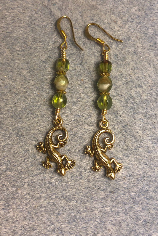 Small gold lizard charm earrings adorned with olive green Czech glass beads