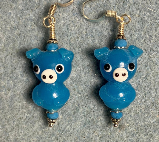 Blue lamp work standing pig bead earrings adorned with blue Chinese crystal beads.