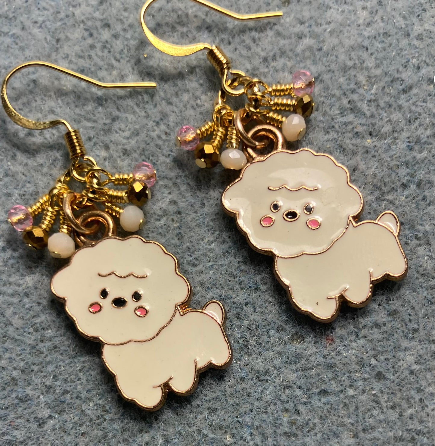 White, pink, and gold enamel puppy dog charm earrings adorned with tiny dangling white, pink, and gold Chinese crystal beads.