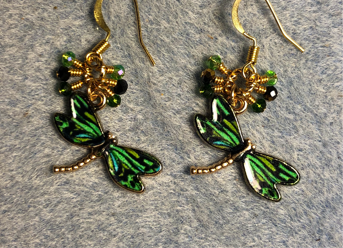 Emerald green and black enamel dragonfly charm earrings adorned with tiny dangling emerald green and black Chinese crystal beads.