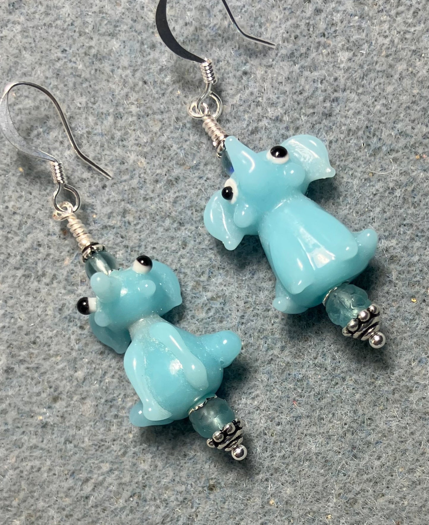 Opaque light aqua lamp work sitting elephant bead earrings adorned with light aqua Czech glass beads.