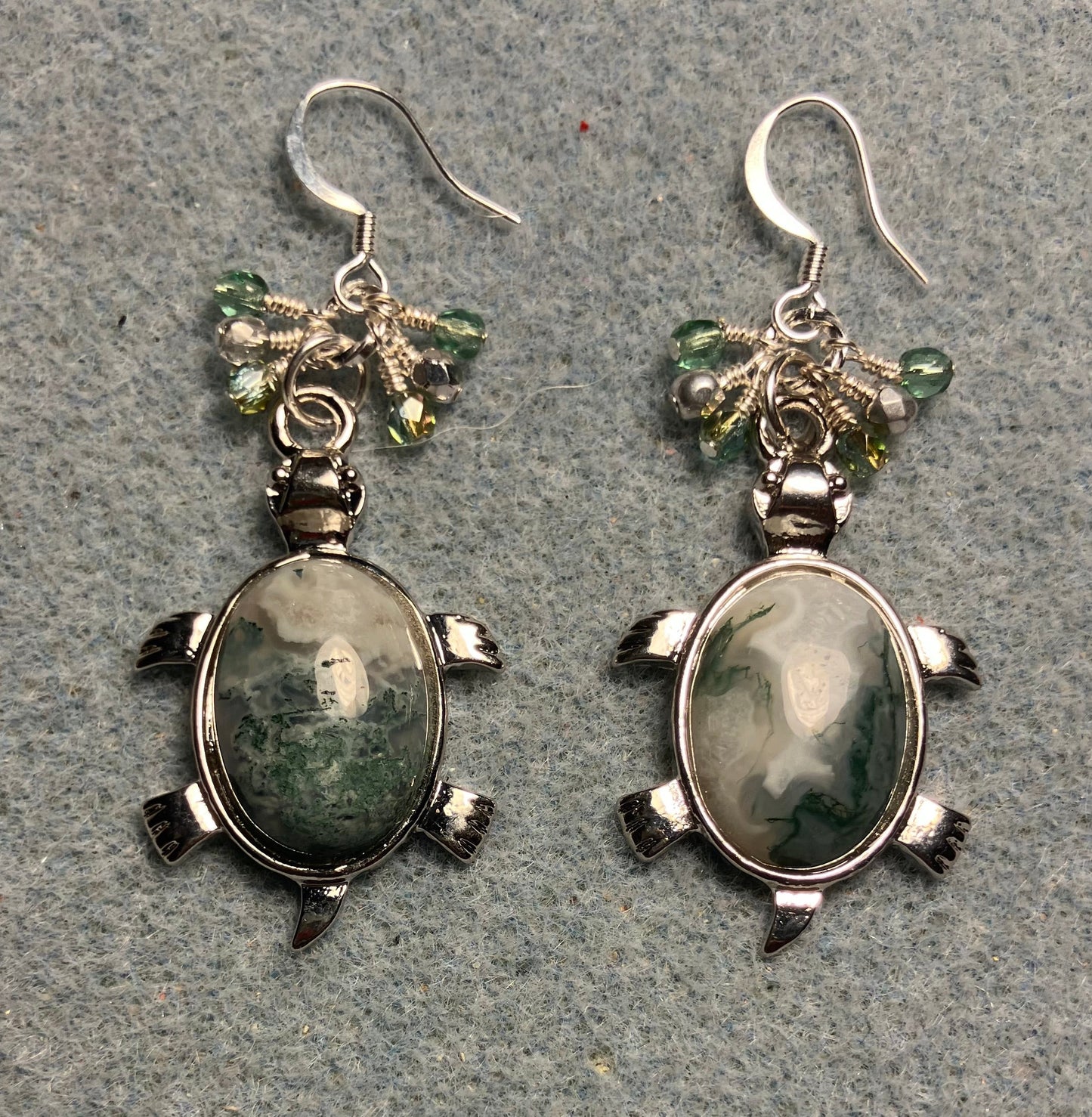 Large silver and green Indian agate gemstone turtle charm earrings adorned with small dangling green and silver Czech glass beads.