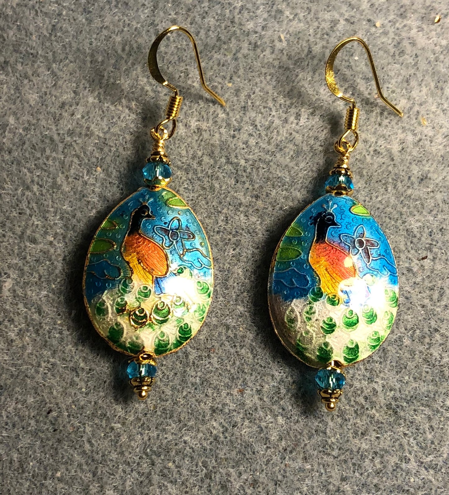 Turquoise, orange, and green cloisonné peacock bead earrings adorned with turquoise Chinese crystal beads.