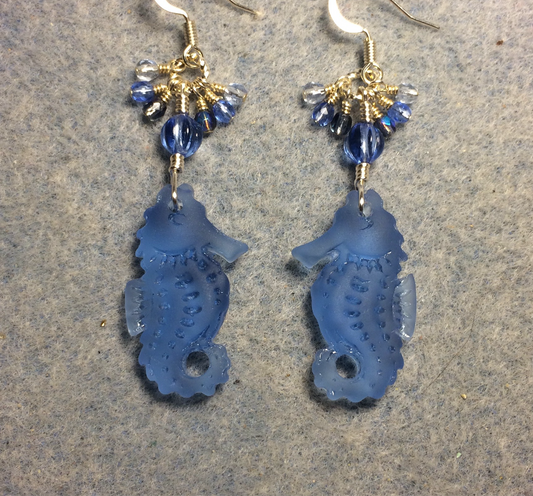 Light blue sea glass seahorse pendant bead earrings adorned with light blue Czech glass beads and small dangling light blue Czech glass beads.