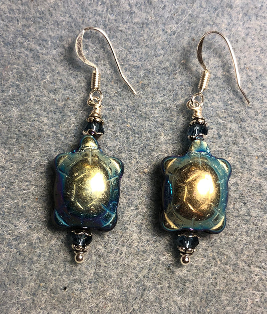 Metallic blue black Czech glass turtle bead earrings adorned with blue Chinese crystal beads.