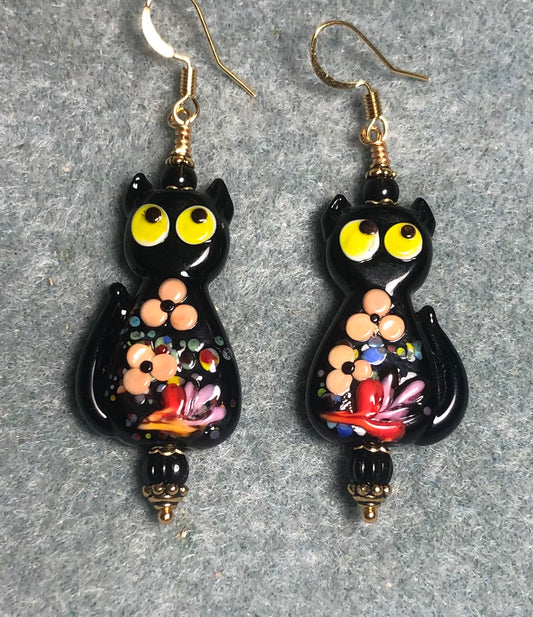 Black, tan, and yellow lamp work cat bead earrings adorned with black Czech glass beads.