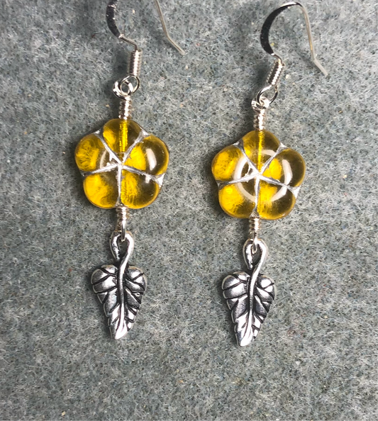 Yellow (with silver inlay) Czech glass puffy flower bead earrings adorned with silver Tierracast leaf charms.