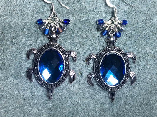 Large silver and blue rhinestone turtle charm earrings adorned with small dangling blue and silver Czech glass beads.