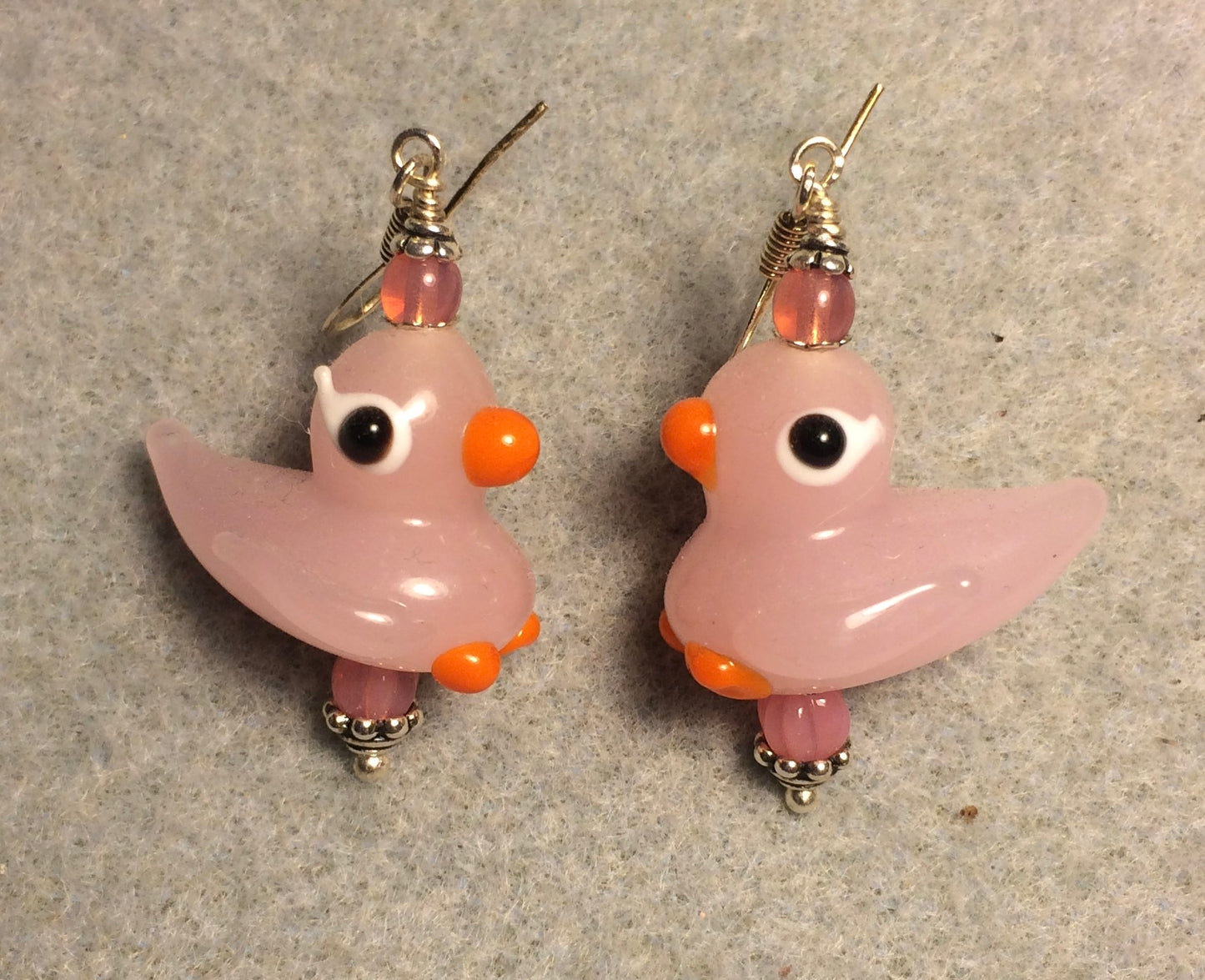 Pink and orange lamp work duck bead earrings adorned with pink Czech glass beads.