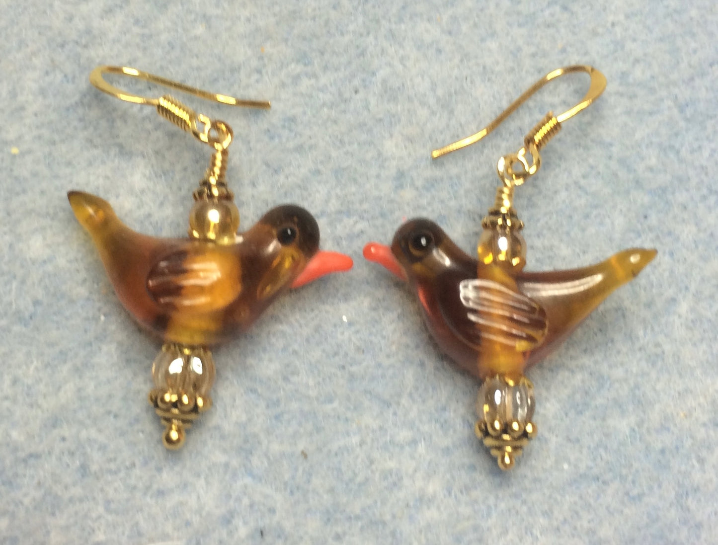 Translucent topaz lamp work songbird bead earrings adorned with topaz Czech glass beads.