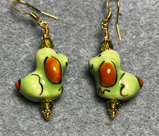 Olive green and brown ceramic puppy dog bead earrings adorned with sparkly olive green Chinese crystal beads.