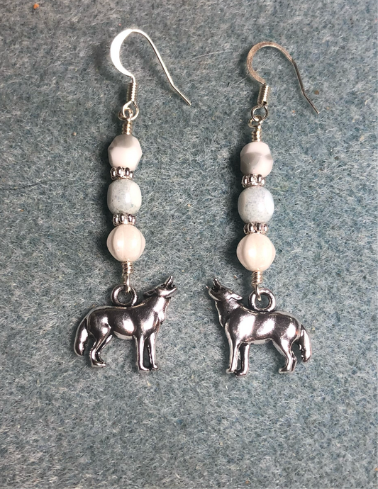 Silver howling wolf charm earrings adorned with white Czech glass beads.