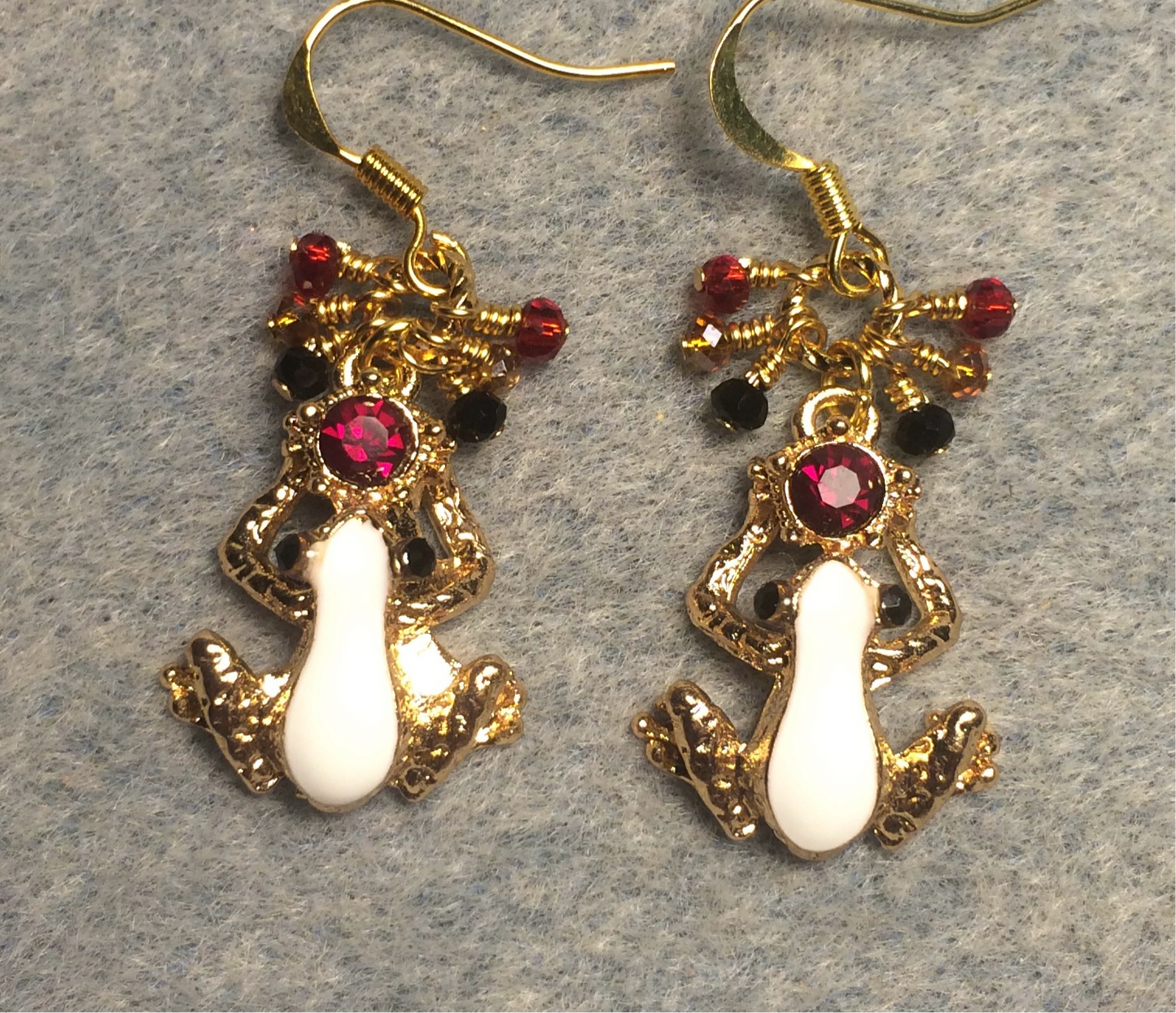 White, red, and gold enamel and rhinestone frog charm earrings adorned with tiny dangling white, red, and amber Chinese crystal beads.