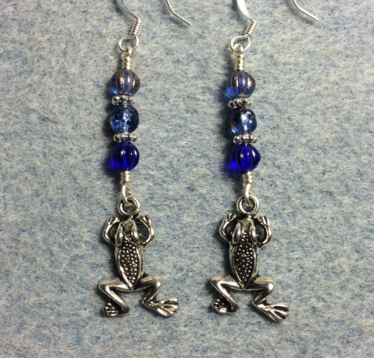 Silver frog charm earrings adorned with small dark blue Czech glass beads.