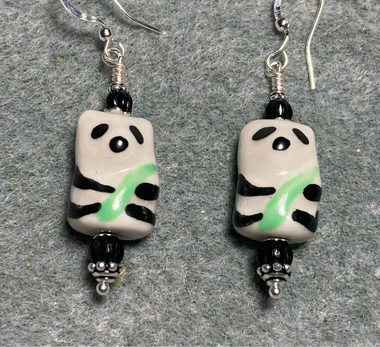 Black, white, and green ceramic panda bear bead earrings adorned with black Czech glass beads.
