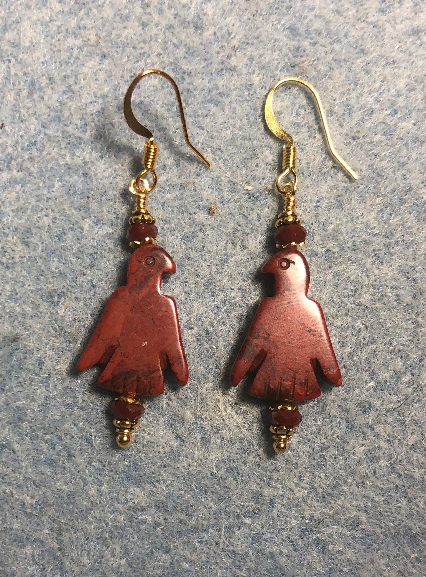 Red poppy jasper gemstone eagle bead earrings adorned with dark red Chinese crystal beads.