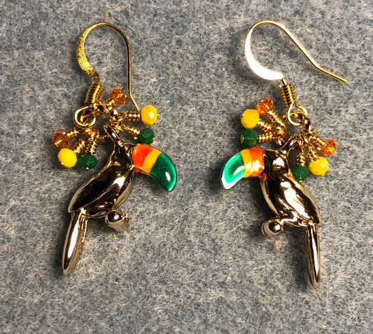 Rose gold and green, orange, and yellow enamel toucan charm earrings adorned with tiny dangling green, orange, and yellow Chinese crystal beads.