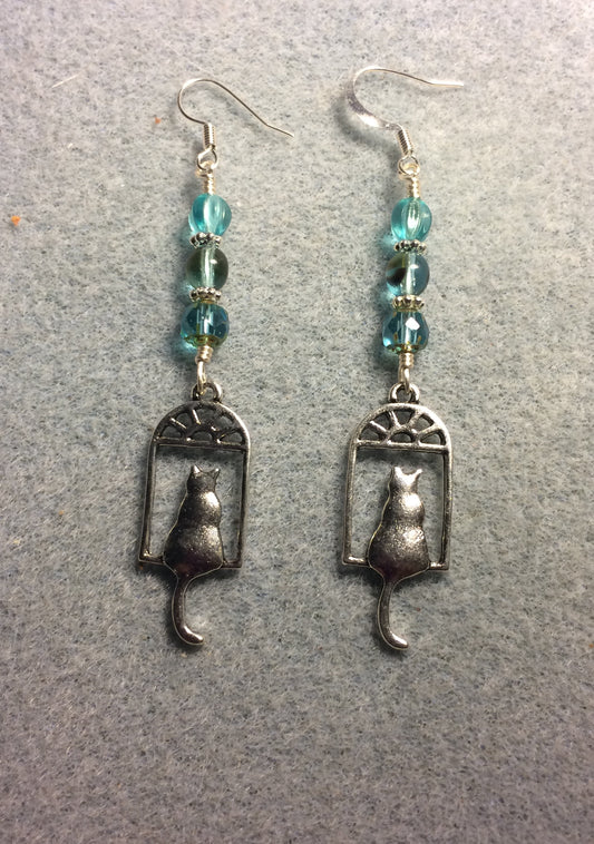 Silver cat sitting in a window charm earrings adorned with light turquoise Czech glass beads