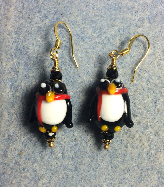 Black, white, and red lamp work penguin bead earrings adorned with black Chinese crystal beads.