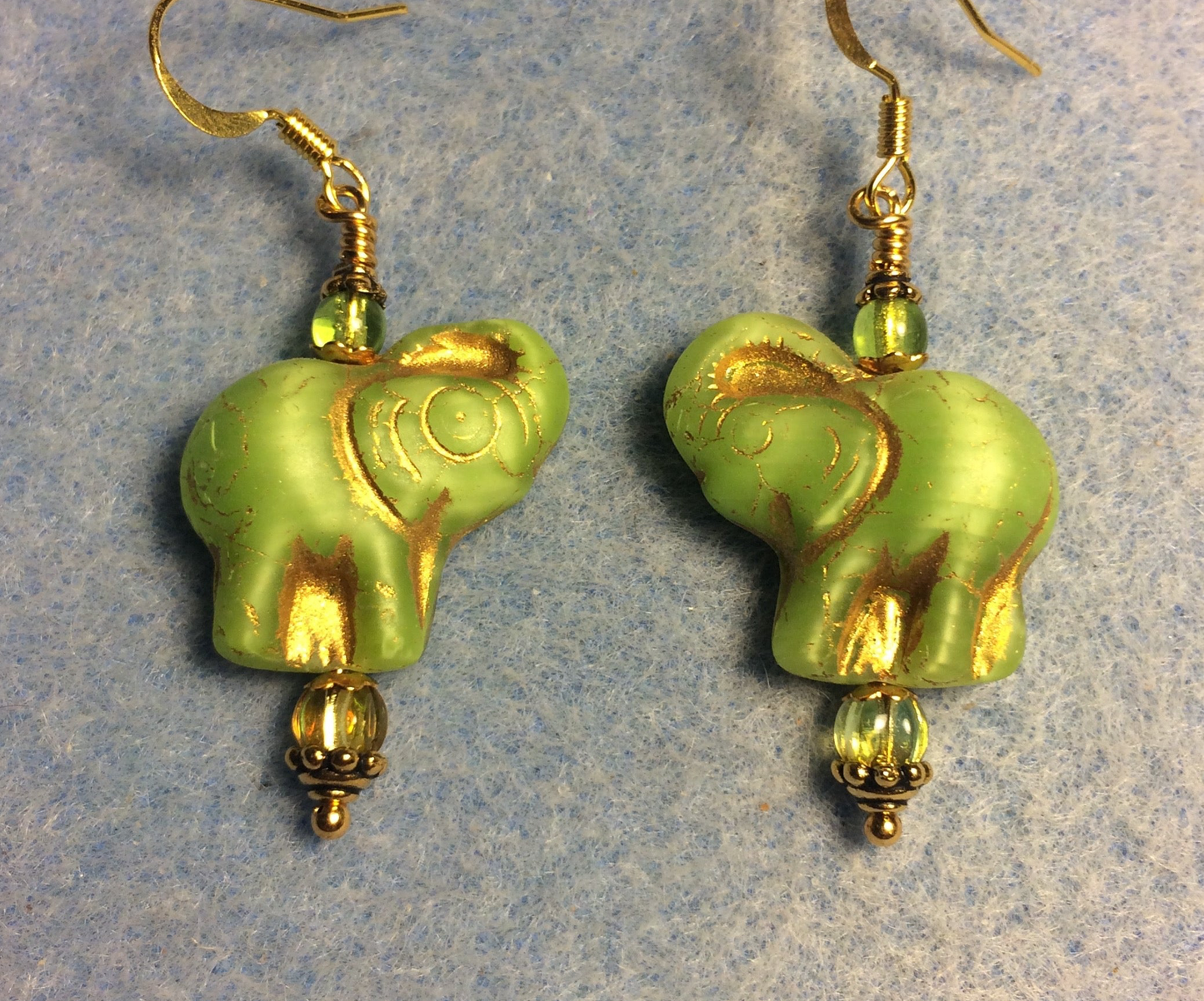 Lime green (with gold inlay) Czech glass elephant bead earrings adorned with lime green Czech glass beads.