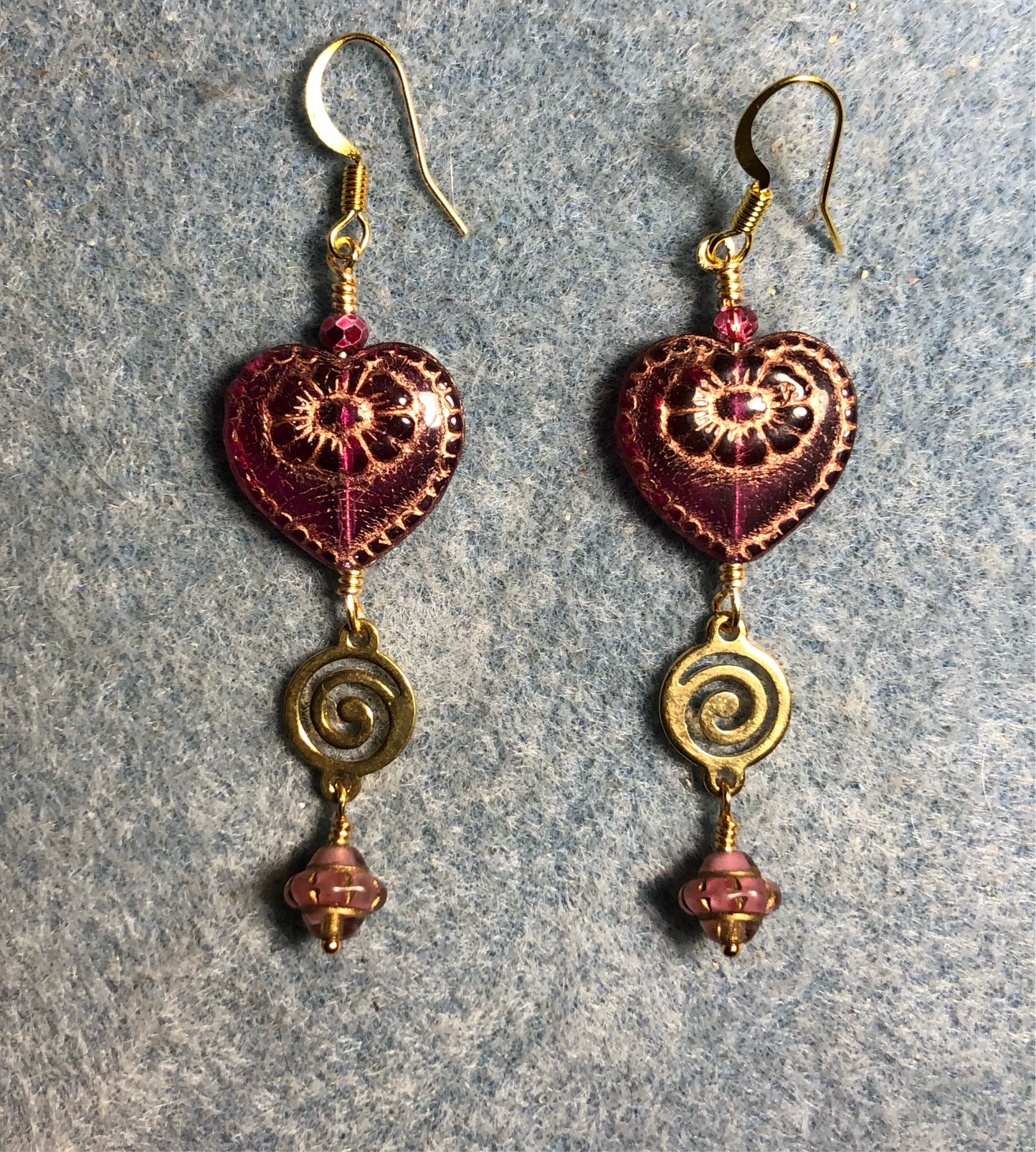 Purple pink (with gold inlay) Czech glass heart bead earrings adorned with gold swirly links and purple pink Czech glass Saturn beads.