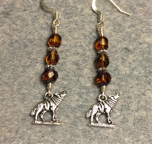 Silver howling wolf charm earrings adorned with topaz Czech glass beads