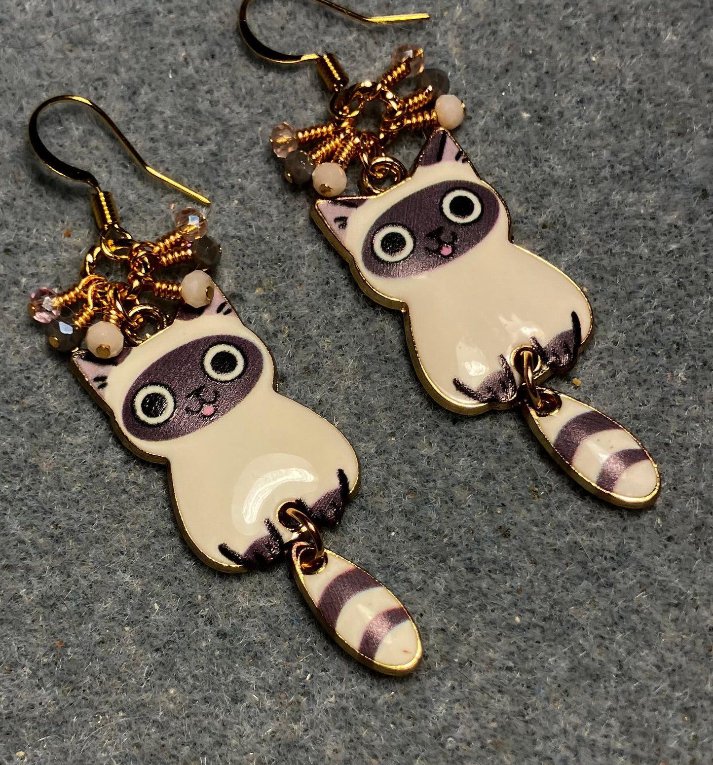 Gray and white enamel tabby cat charm earrings adorned with tiny dangling gray, pink, and white Chinese crystal beads.