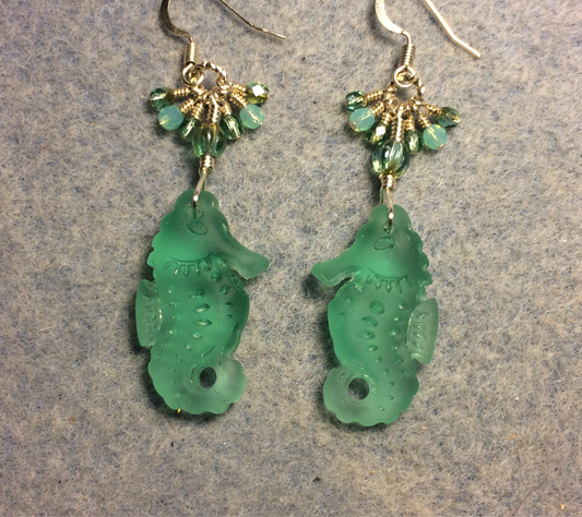 Blue green sea glass seahorse pendant bead earrings adorned with blue green Czech glass beads and small dangling blue green Czech glass beads.