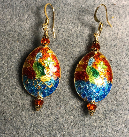 Orange, blue, and green cloisonné peacock bead earrings adorned with orange Chinese crystal beads.