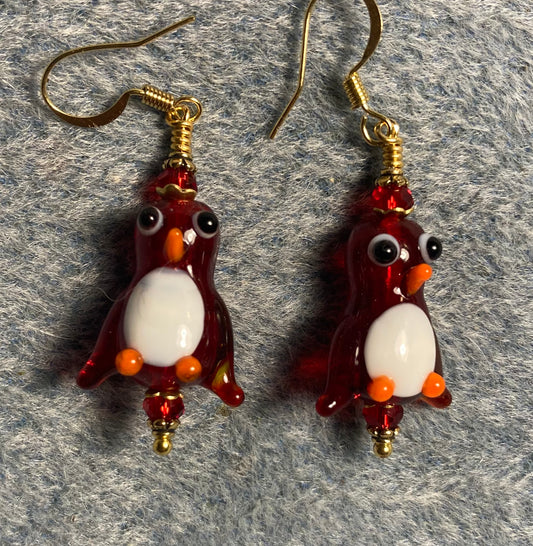 Translucent dark red and white lamp work penguin bead earrings adorned with dark red Chinese crystal beads.