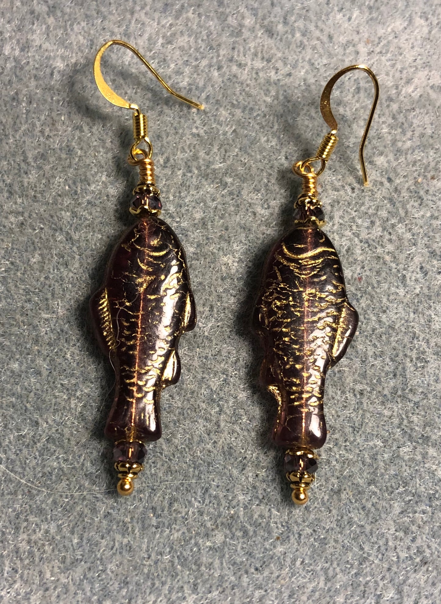 Purple (with gold inlay) Czech glass fish bead earrings adorned with purple Chinese crystal beads.