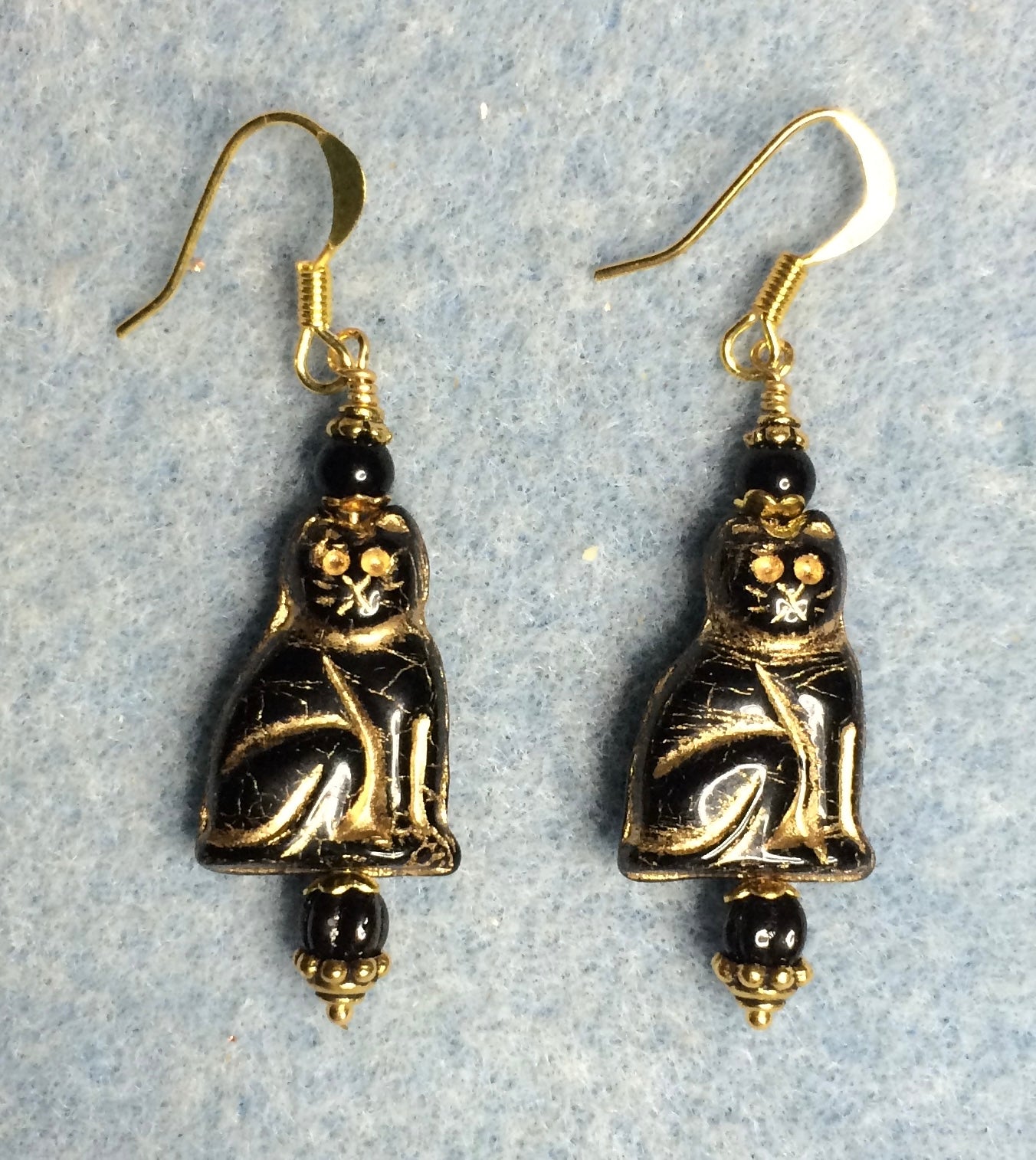 Black (with gold inlay) Czech glass cat bead earrings adorned with black Czech glass beads.