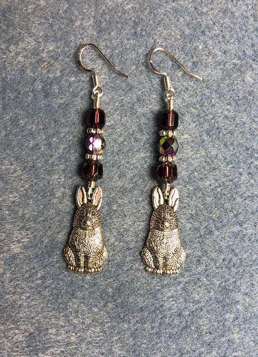 Silver rabbit charm earrings adorned with purple Czech glass beads.
