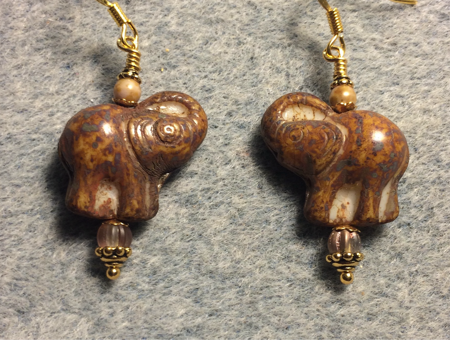 Brown (with cream inlay) Czech glass elephant bead earrings adorned with brown Czech glass beads.