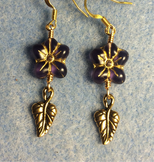 Dark purple (with gold inlay) Czech glass puffy flower bead earrings adorned with gold Tierracast leaf charms.