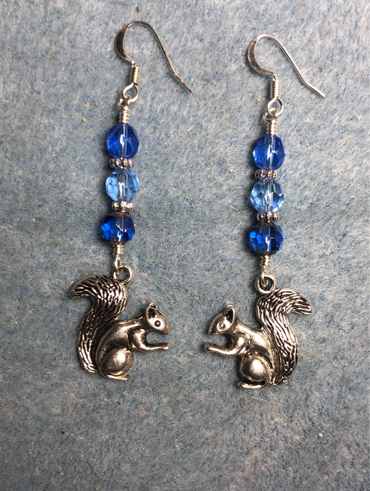 Silver squirrel charm earrings adorned with blue Czech glass melon beads.
