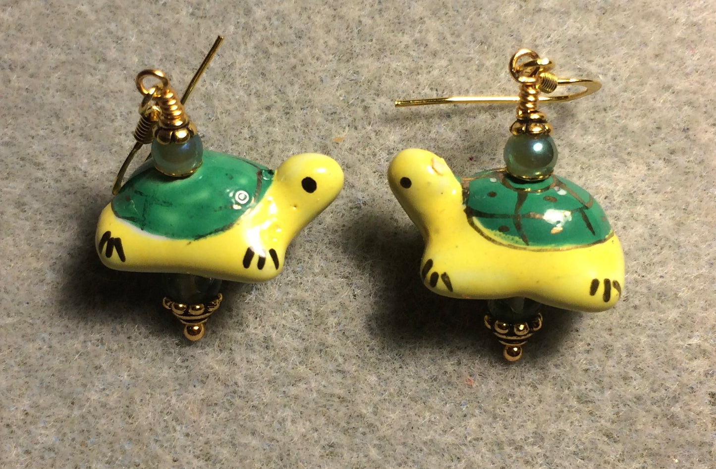 Green and yellow ceramic turtle bead earrings adorned with green Chinese crystal beads.