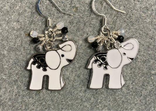 White and black enamel elephant charm earrings adorned with tiny dangling white, silver, and black Czech glass beads.