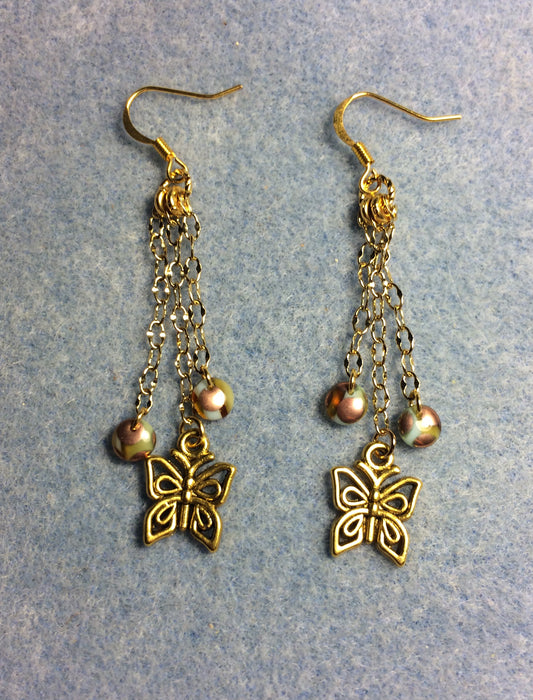 Gold butterfly charm earrings attached to gold chain and adorned with gold brown Czech glass lentil beads.