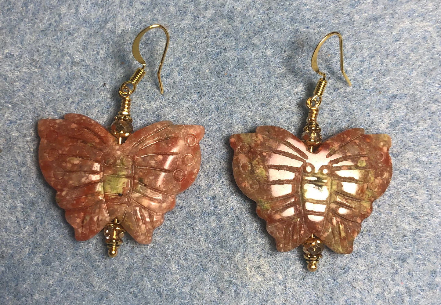 Large orange crazy agate gemstone butterfly bead earrings adorned with gold Chinese crystal beads.