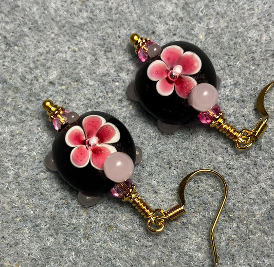 Dark red and pink lamp work turtle bead earrings adorned with hot pink Chinese crystal beads.
