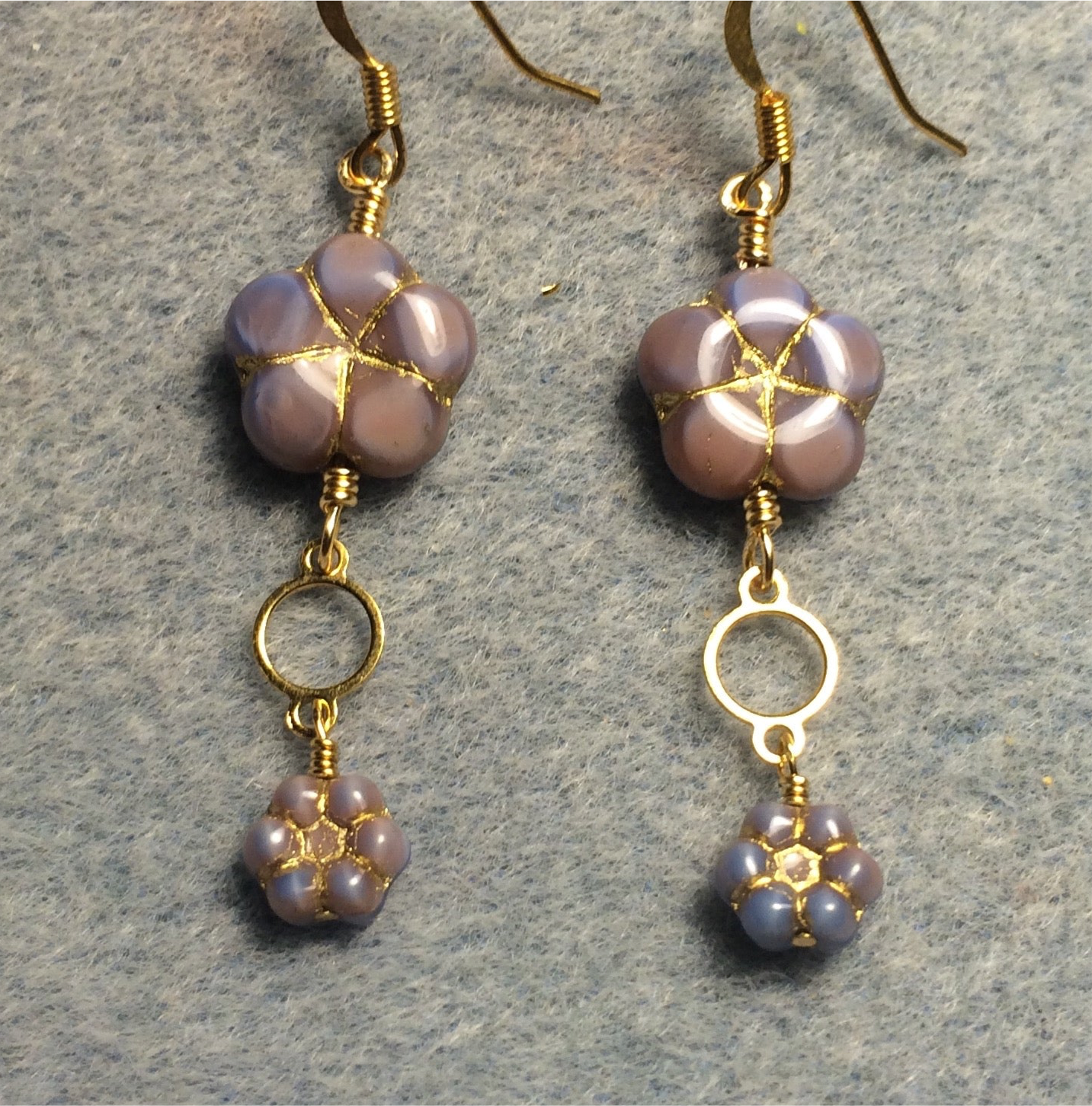 Purple pink Czech glass puffy flower bead earrings adorned with gold circle connectors and small purple pink Czech glass daisy beads.