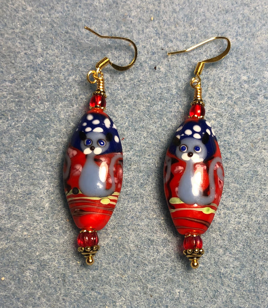 Blue, red, and white lamp cat bead earrings adorned with red Czech glass beads.