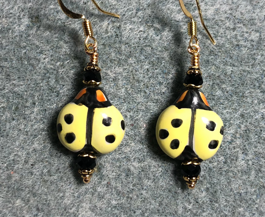 Yellow and black ceramic ladybug bead earrings adorned with black Chinese crystal beads.