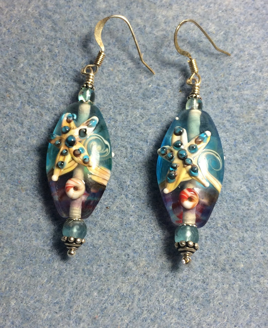 Light aqua, lavender, and tan lamp work starfish bead earrings adorned with light aqua Chinese crystal beads.