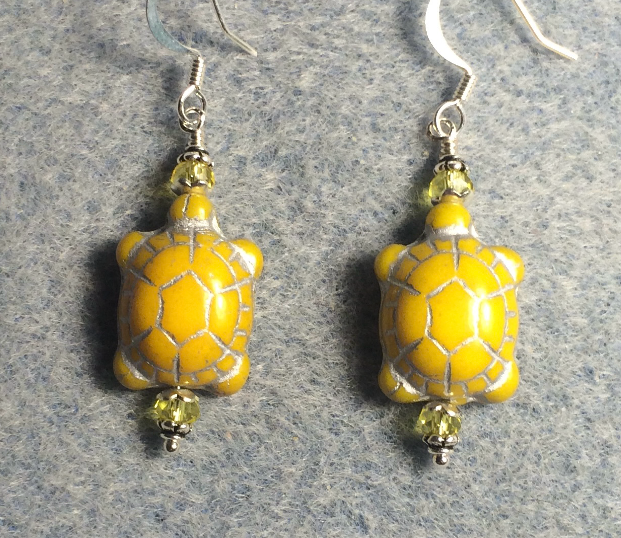 Opaque yellow (with silver inlay) Czech glass turtle bead earrings adorned with yellow Chinese crystal beads.