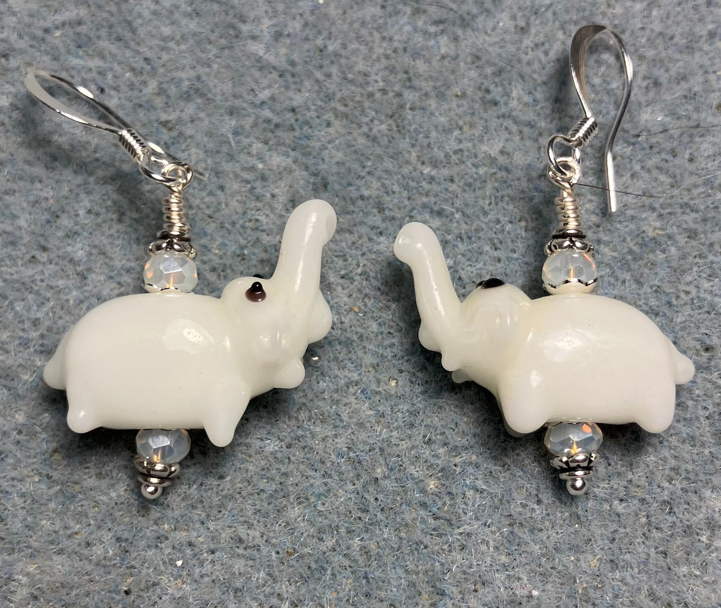 Small white lamp work elephant bead earrings adorned with white Chinese crystal beads.
