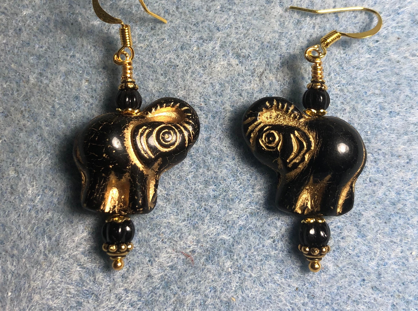 Black (with gold inlay) Czech glass elephant bead earrings adorned with black Czech glass beads.